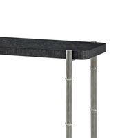 Close-up of black burl console table corner, top detail.