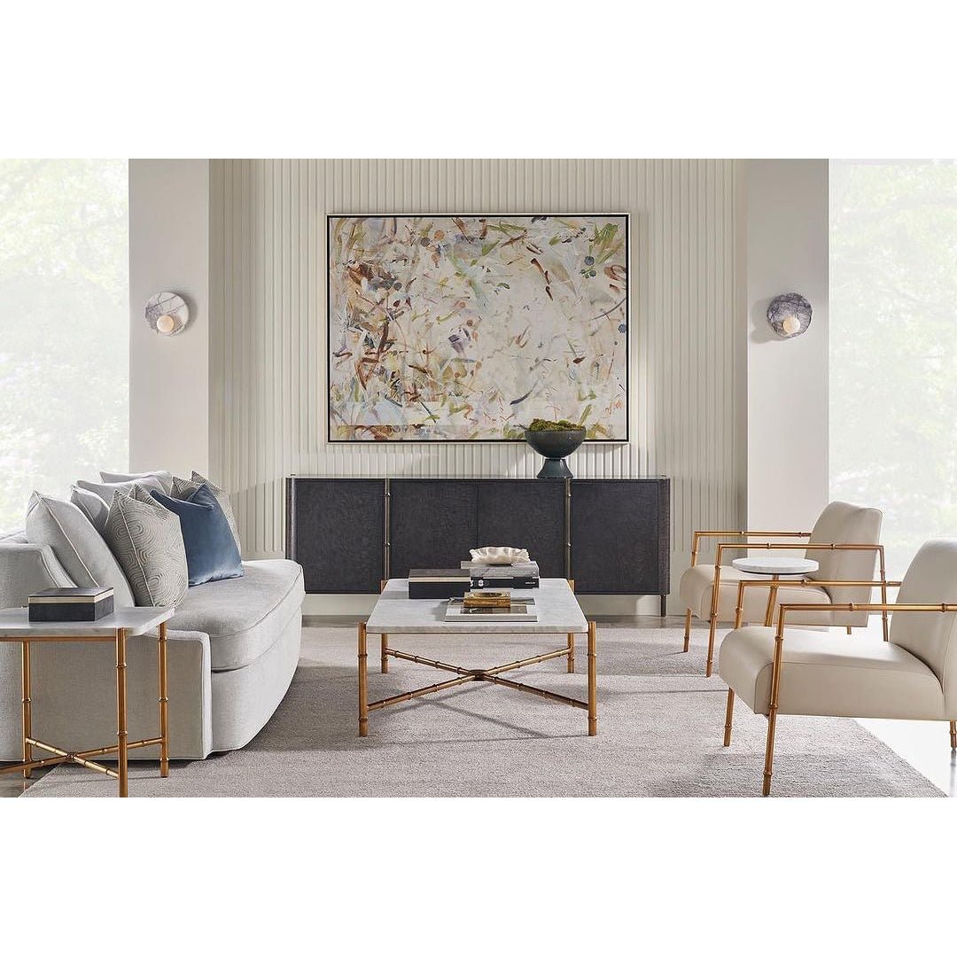 Black sideboard in modern living room setup, artwork above.