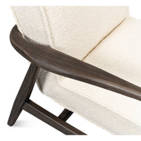 Mid-century boucle armchair angled armrest and cushion.