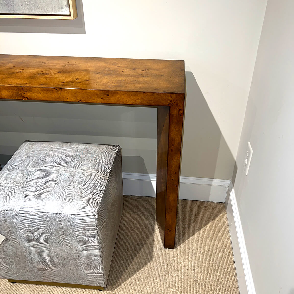 Console table corner with cube seat underneath.