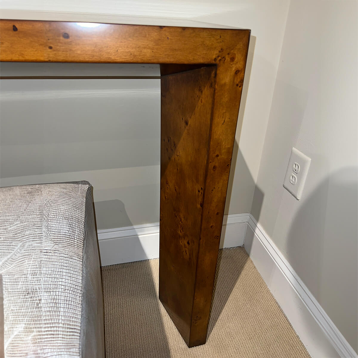 Console table leg detail and adjoining wall.