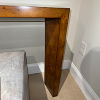 Console table leg detail and adjoining wall.