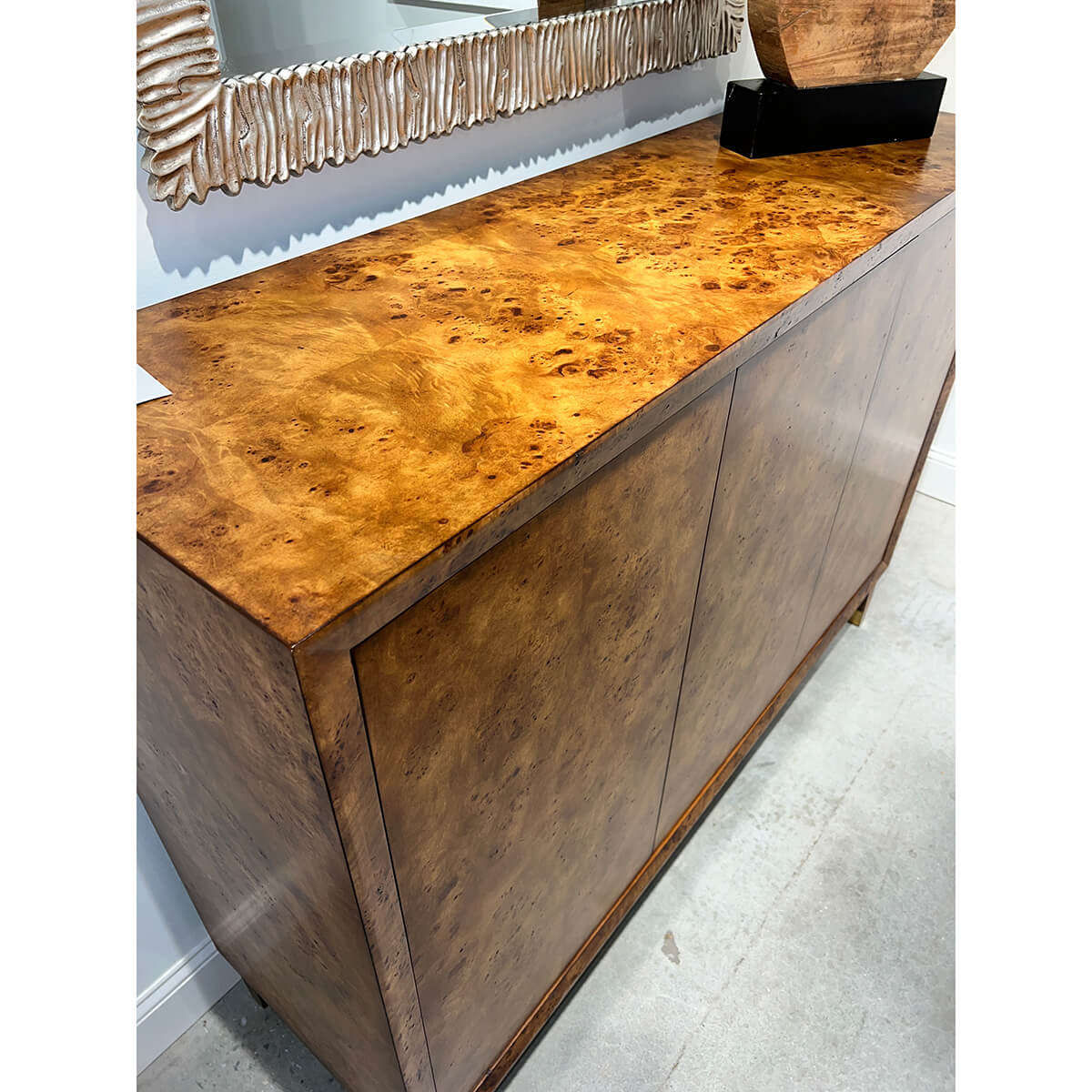 Top surface view of mid-century burl credenza with decor.