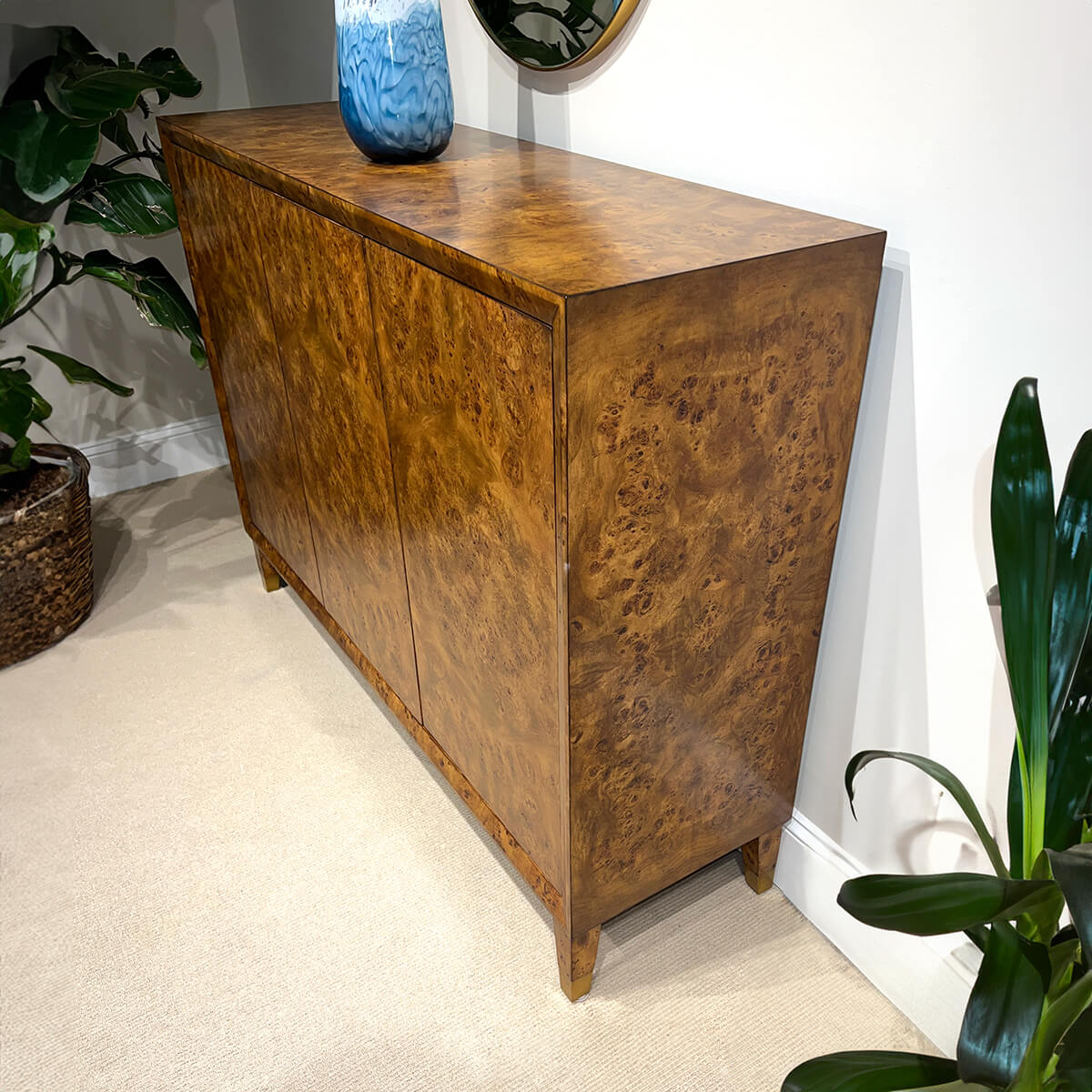Side view of mid-century burl credenza in room décor.