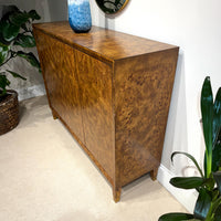 Side view of mid-century burl credenza in room décor.