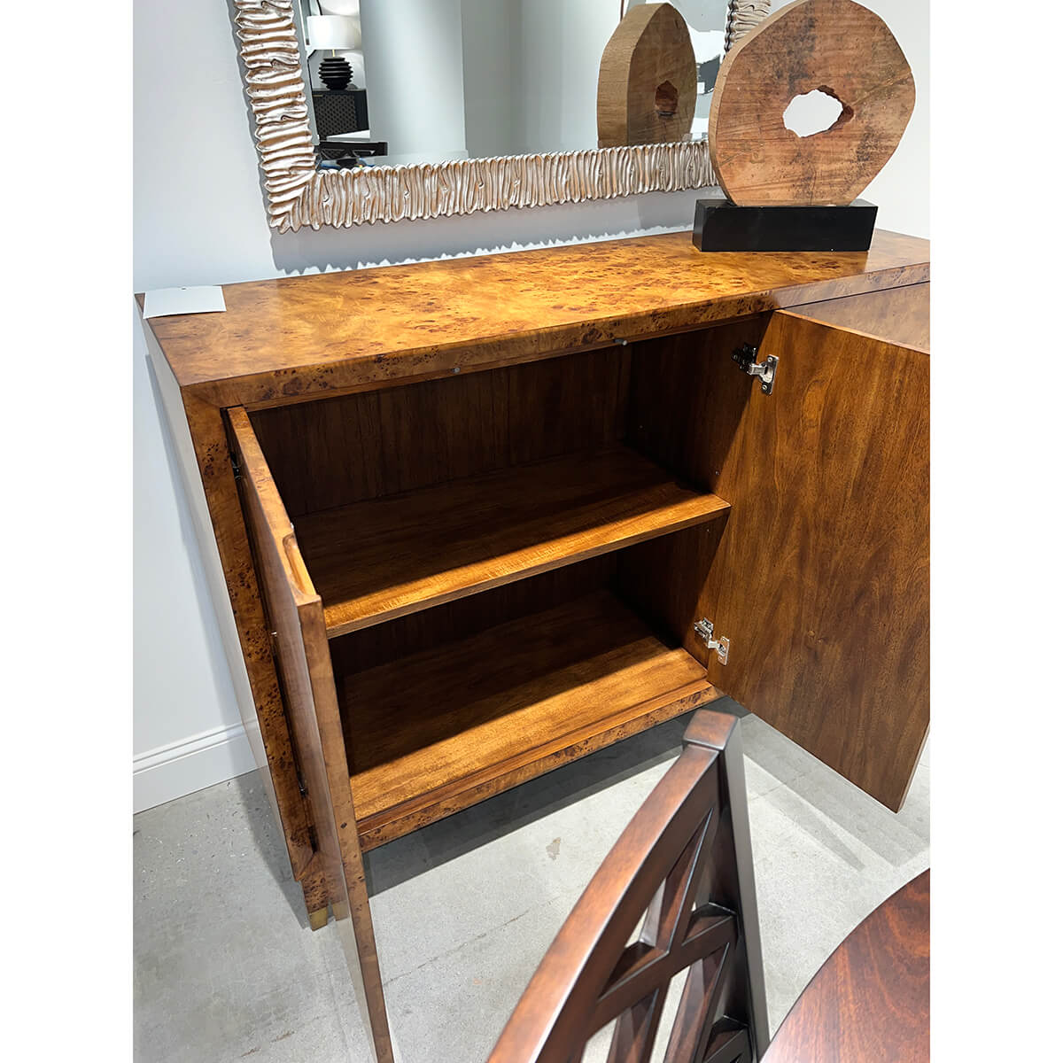 Inside view of mid-century burl credenza showcasing shelves.
