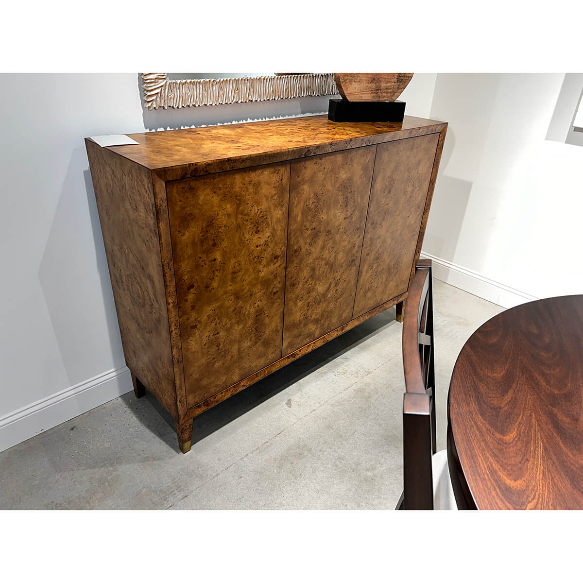 Mid-century burl credenza in dining room corner setting.