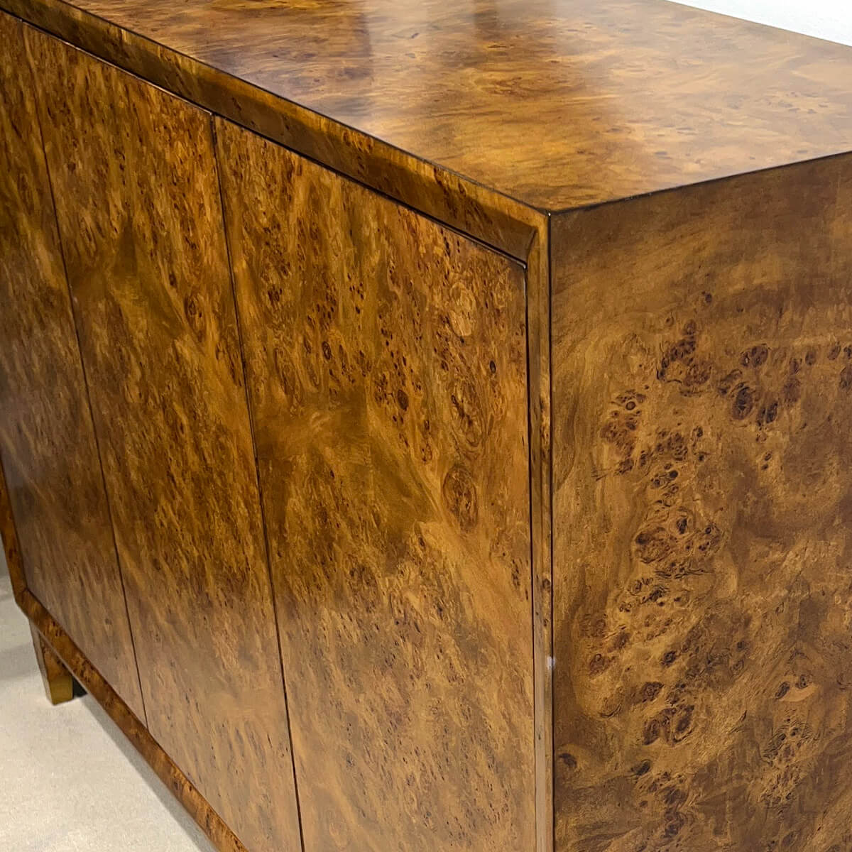 Close-up of mid-century burl credenza's wood grain pattern.