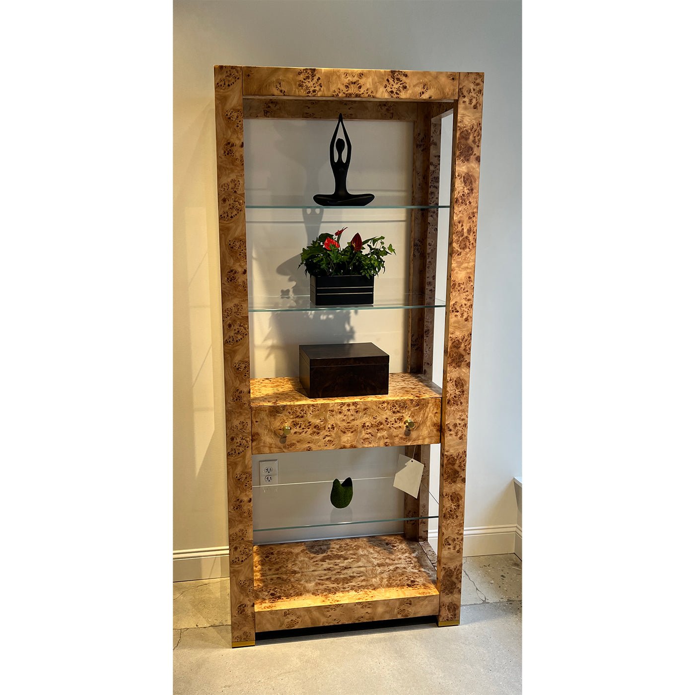 Burl étagère bookshelf in room with decorative items.
