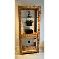 Burl étagère bookshelf in room with decorative items.