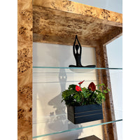 Top section of burl étagère bookshelf with decor.