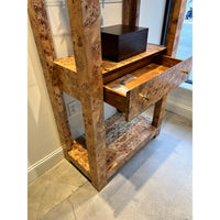 Open drawer on burl étagère bookshelf showing interior.