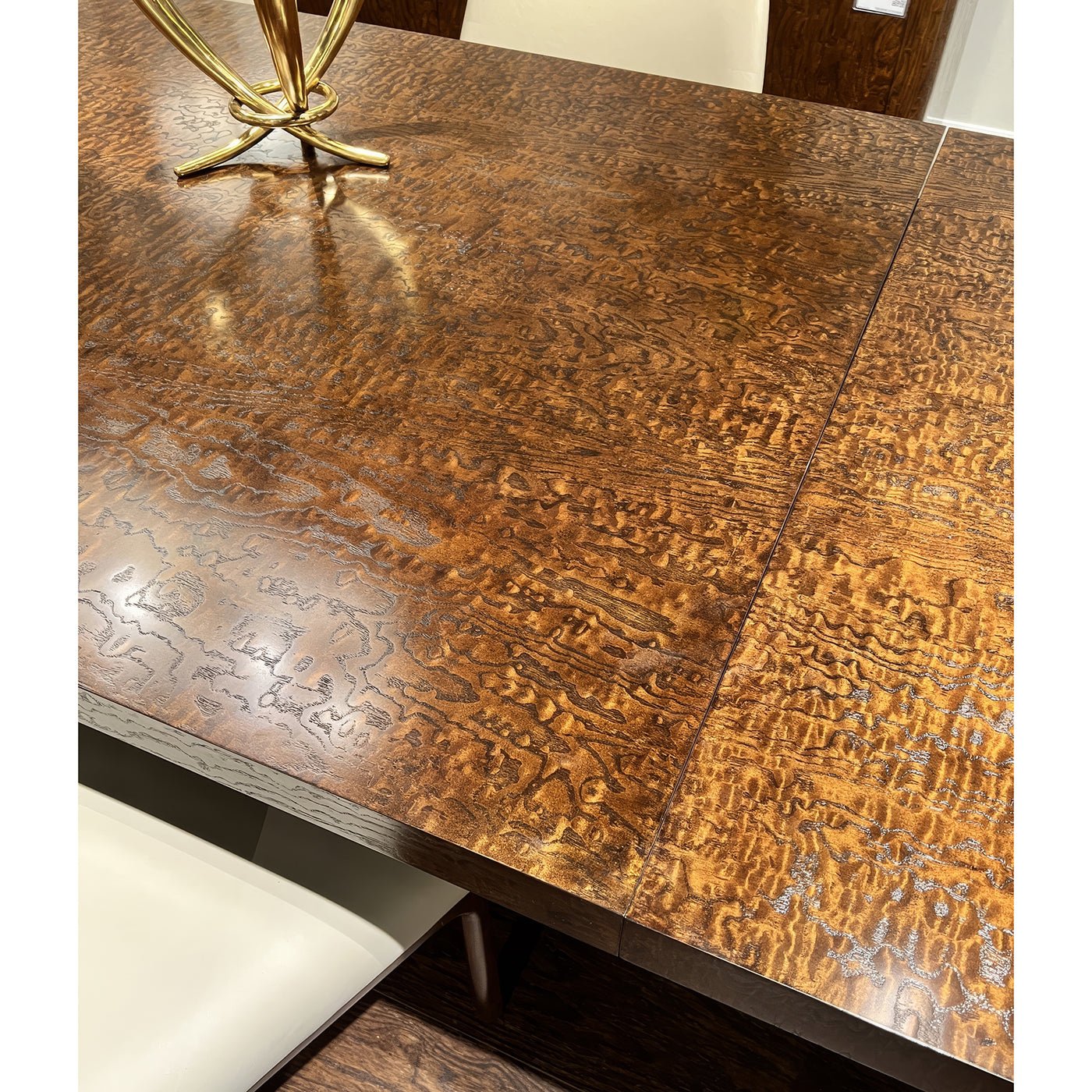 Detailed view of burl wood dining table surface.