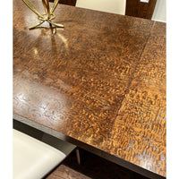 Detailed view of burl wood dining table surface.