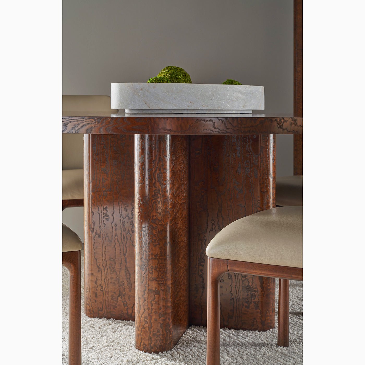 Detailed view of dining table base and chairs.