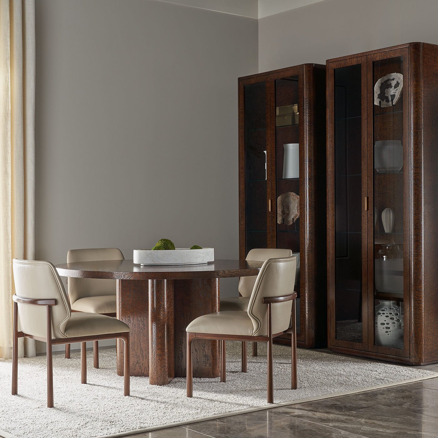 Dining table with chairs, cabinets, and decorative items.