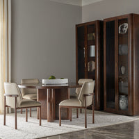 Dining table with chairs, cabinets, and decorative items.