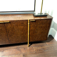 Close-up of burl wood sideboard highlighting design details.
