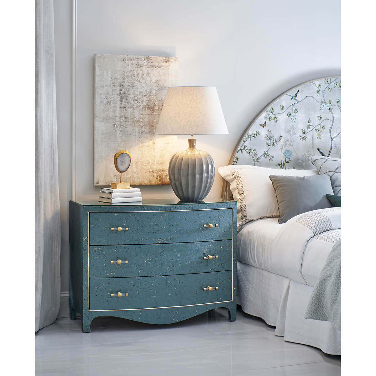 Bedroom scene with king bed and nightstand.