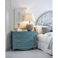 Bedroom scene with king bed and nightstand.