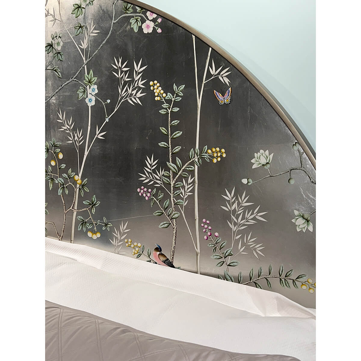 Detailed floral design on king bed headboard.