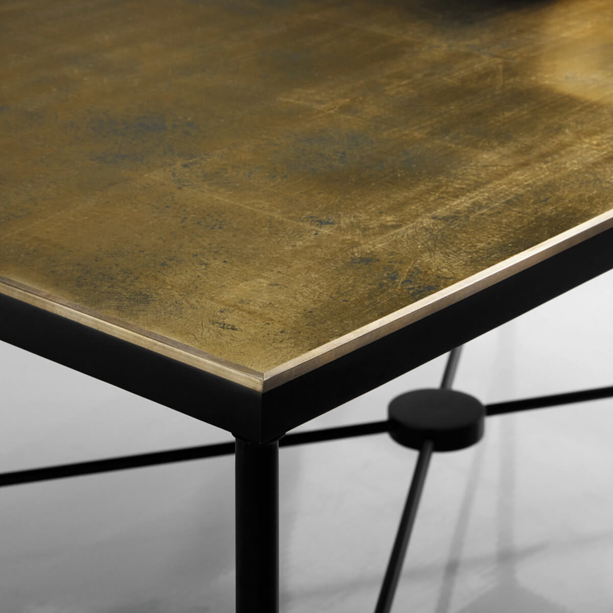 Close-up of table corner showing eglomisé detail.