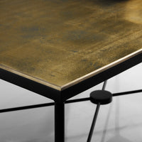 Close-up of table corner showing eglomisé detail.