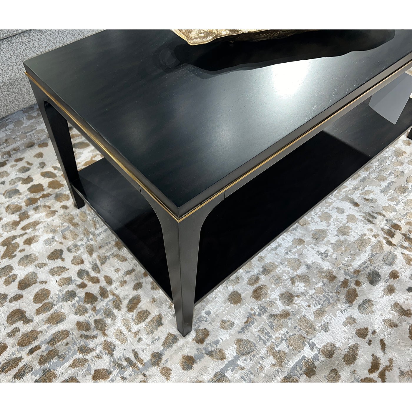 Corner view of mid-century coffee table on patterned rug.