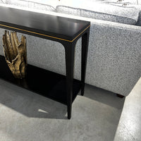 Side view of console table behind a sofa.