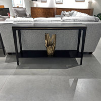 Console table with lower shelf in living room setting.