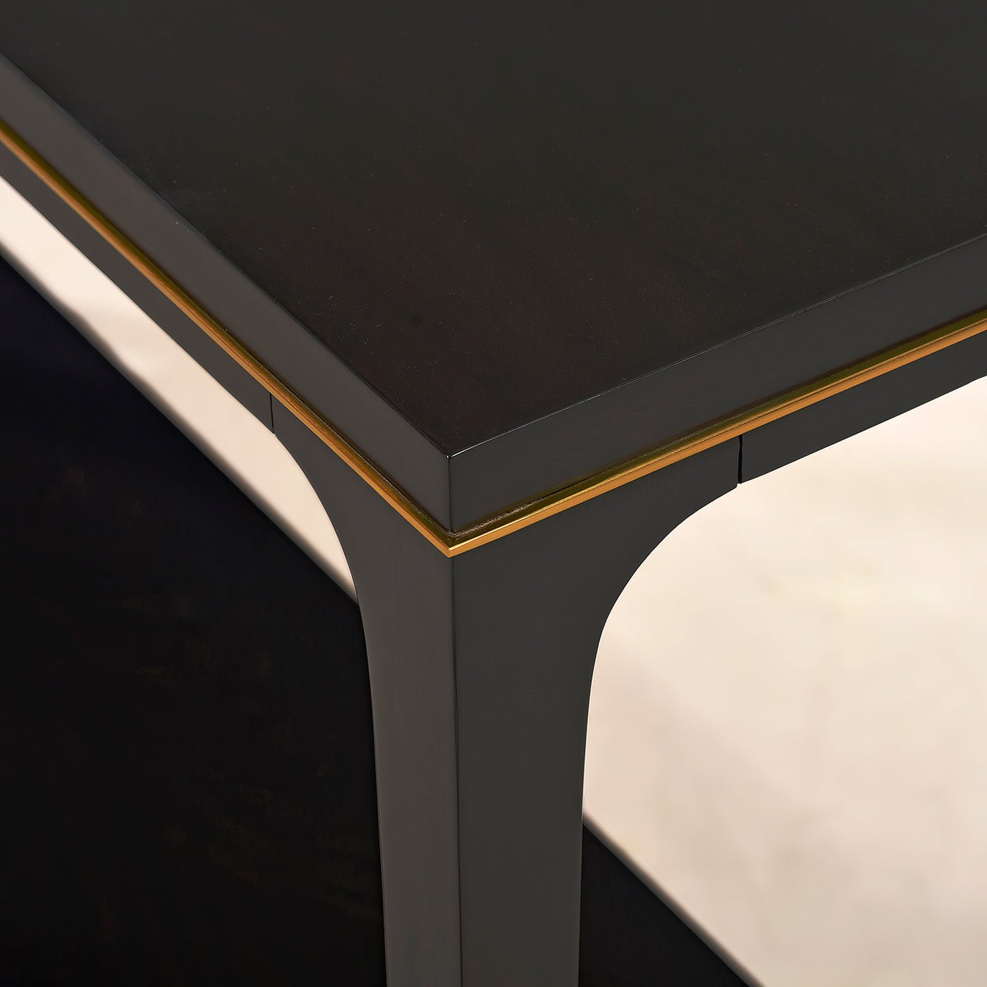 Close-up of tabletop and corner detailing on console table.