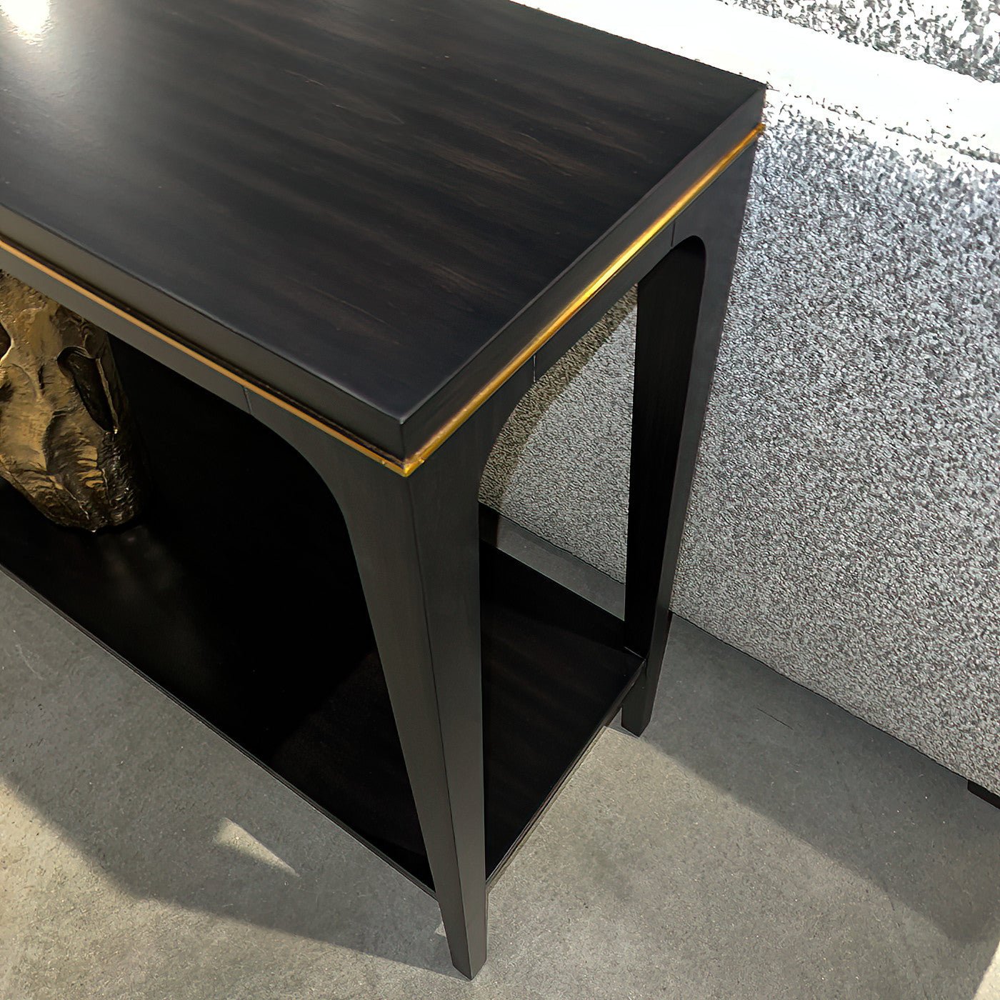 Angled close-up of console table with golden accent.