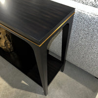 Angled close-up of console table with golden accent.
