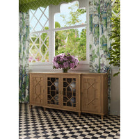 Mid-century credenza in dining room, floral decor, fruitwood.