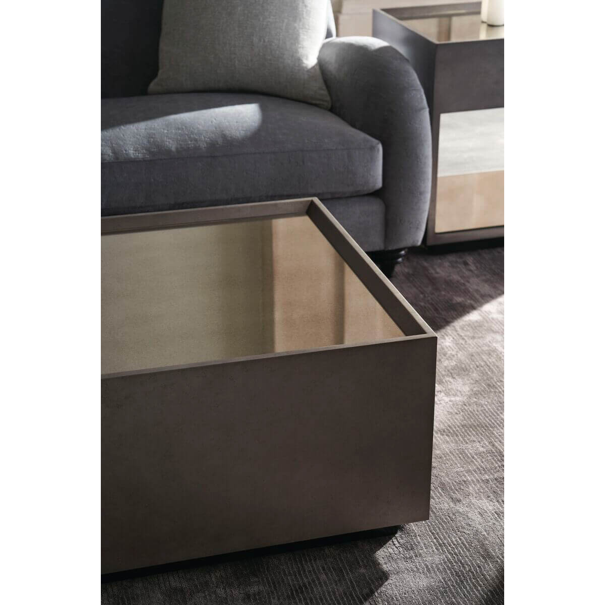 Mid-century cube cocktail table with sofa in background.