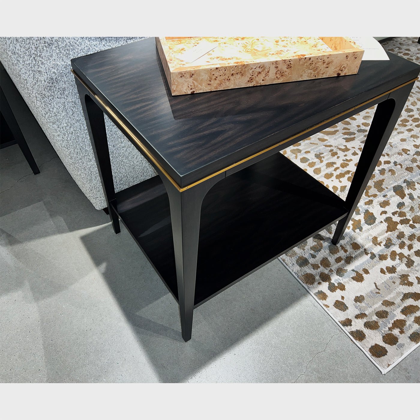 Close-up dark wood end table top and legs.