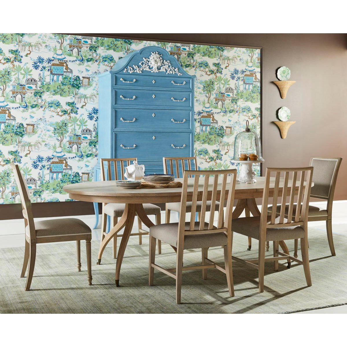 Dining table set with chairs and blue cabinet.
