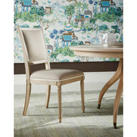 Single chair next to dining table, floral wallpaper.