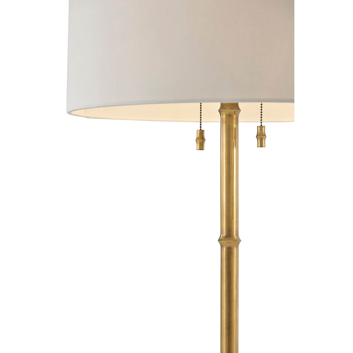 Close-up of gold lamp post with dual pull chains.