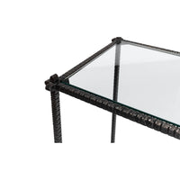 Close-up of table corner, iron and glass detail.