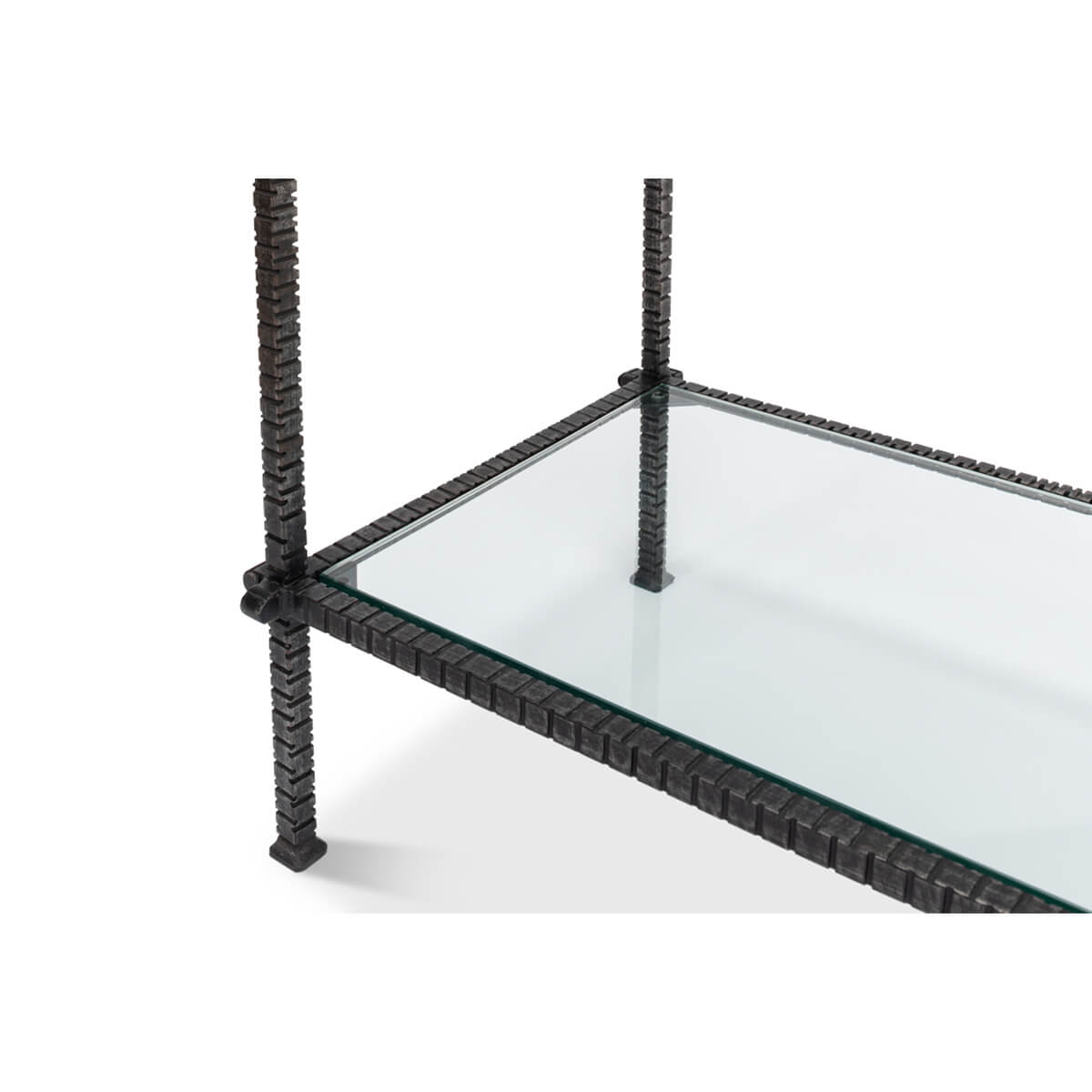 Lower shelf of glass table, metal detail.