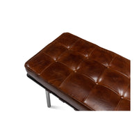 Close-up of tufted leather detail on bench.