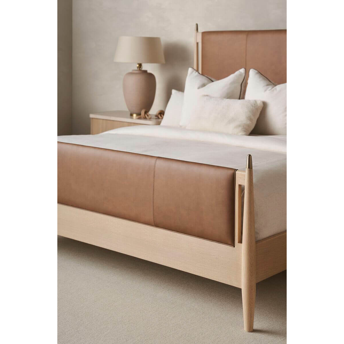 Leather king bed close-up with neutral decor.