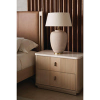 Nightstand with lamp beside mid-century leather queen bed.
