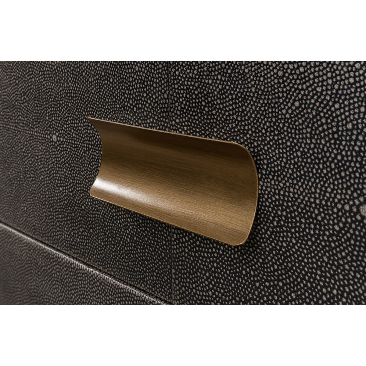 Brass handle close-up on gray leather side table