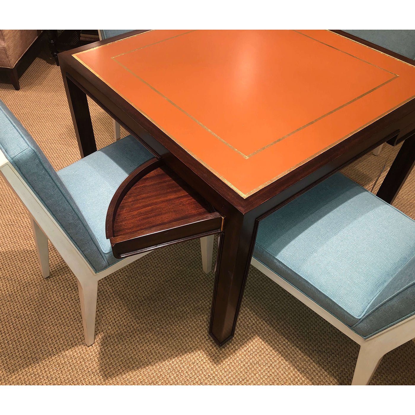 Game table with blue chairs and hidden drawer.