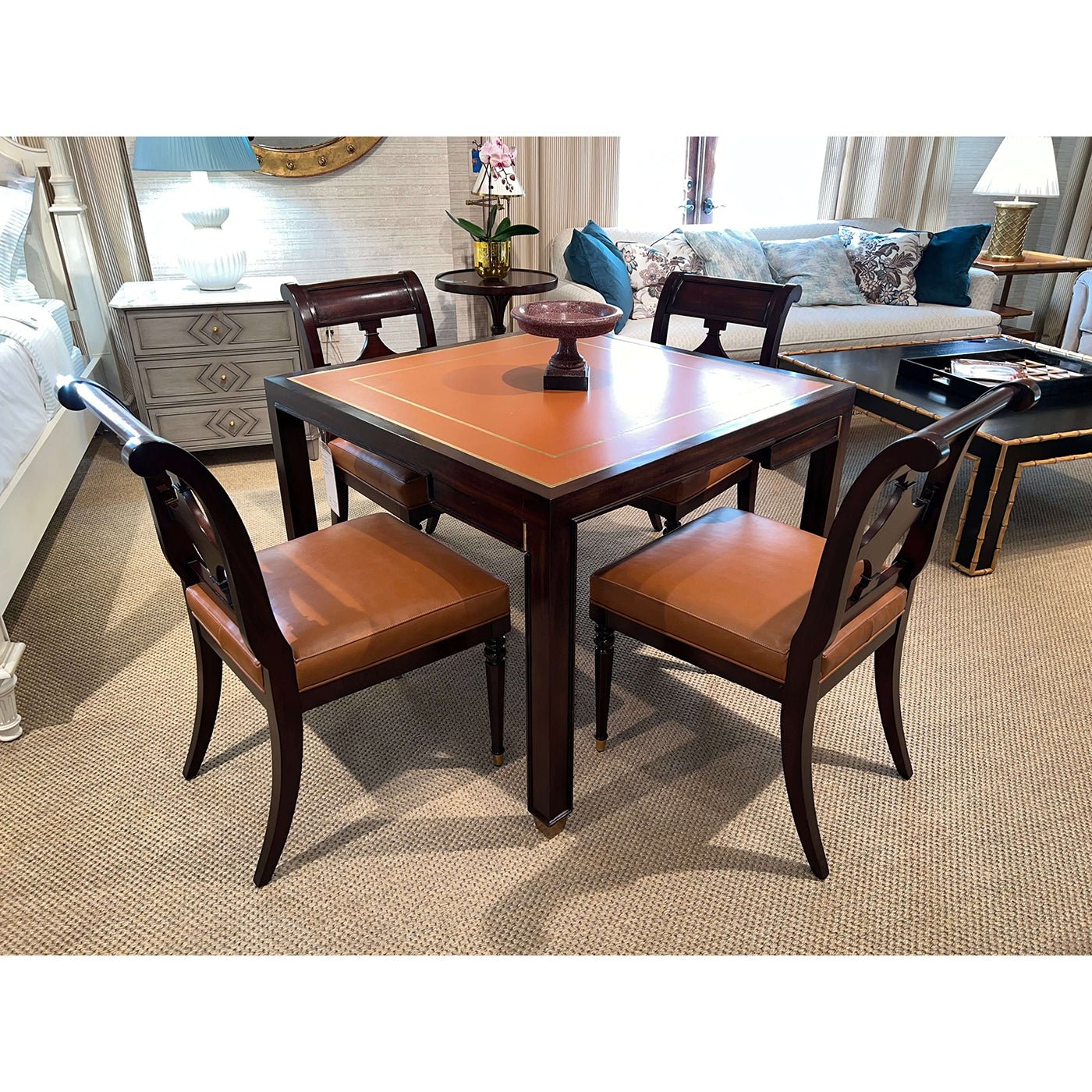 Game table with four chairs in living room setting.