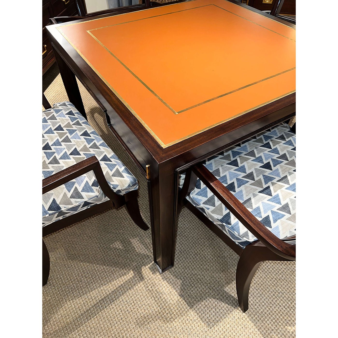 Game table with geometric patterned chairs in room scene.