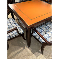 Game table with geometric patterned chairs in room scene.