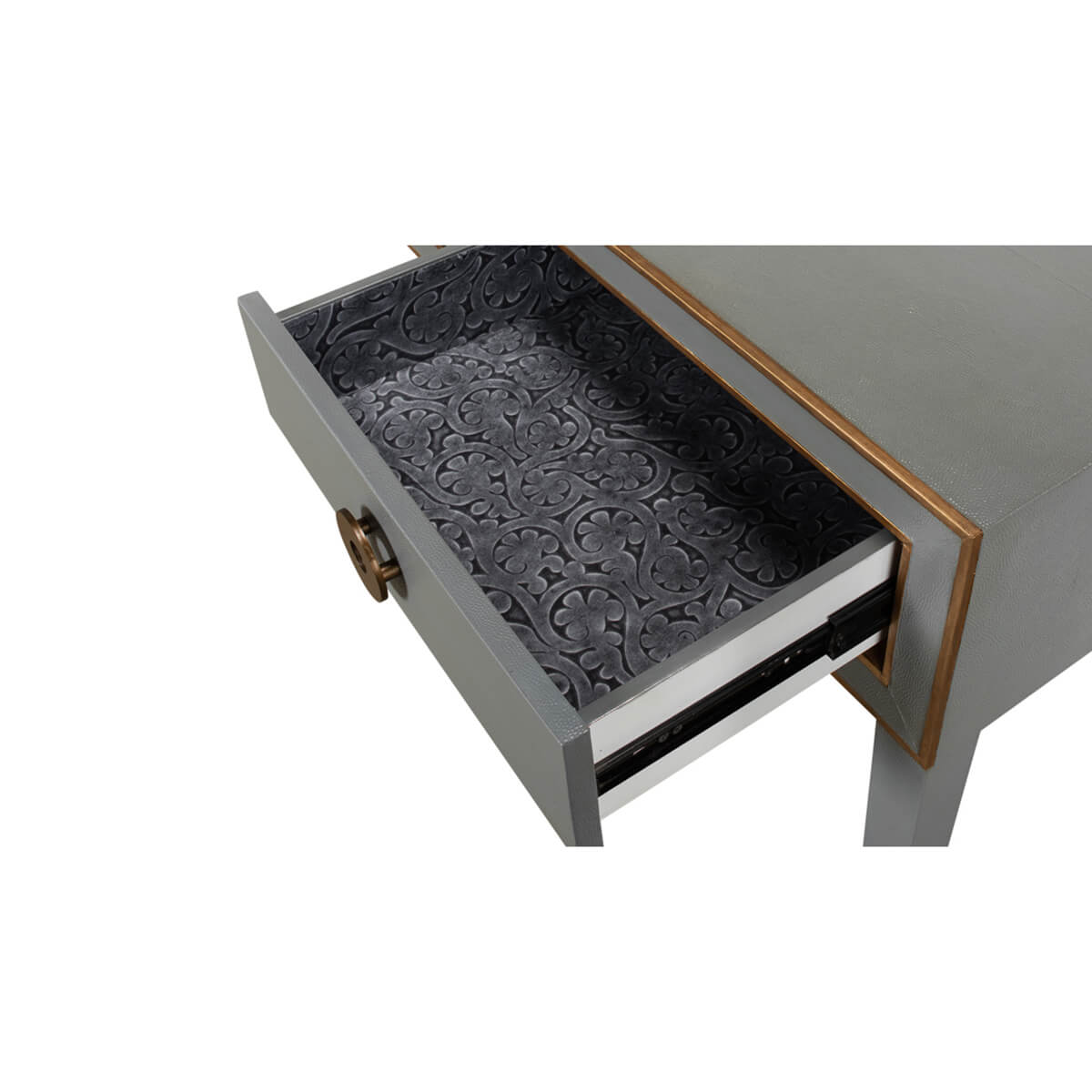 Close-up of console table drawer with decorative lining.